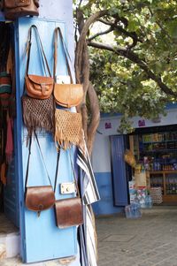 Clothes hanging against wall at market stall