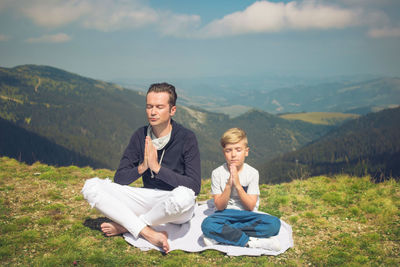 Father and son spending leisure time on mountain