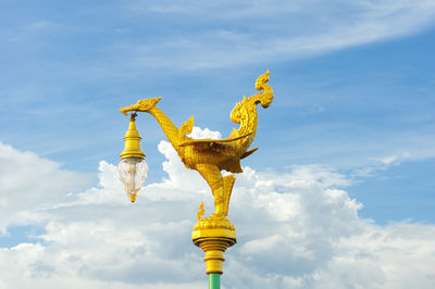 Low angle view of statue against blue sky