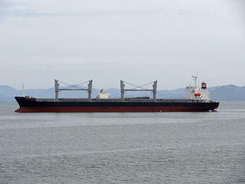 Ship sailing on sea against sky