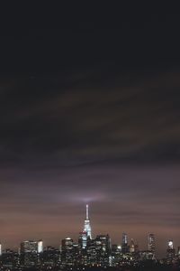 Illuminated cityscape against sky