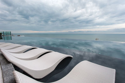 Scenic view of swimming pool by sea against sky