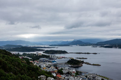 High angle view of buildings by sea against sky