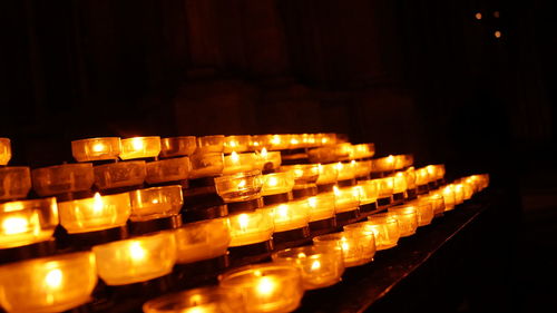 Lit candles in row at night