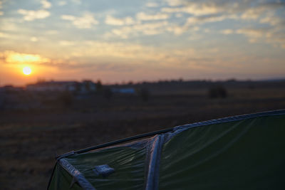 Scenic view of land against sky during sunset