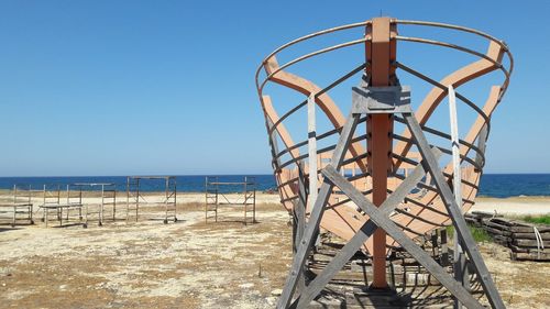 Lifeguard hut on beach against clear sky