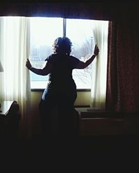 Close-up of woman standing against white wall