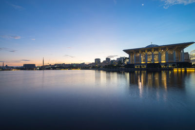 Tuanku mizan zainal abidin mosque by lake against sky