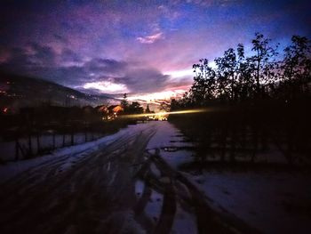 Road with trees in background at dusk