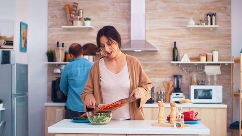 Side view of young woman working at home