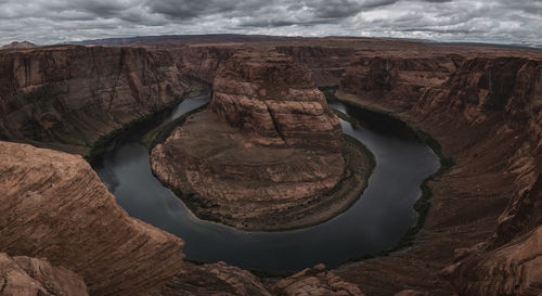 Rock formation and lake against sky