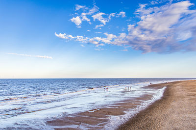 Scenic view of beach against blue sky