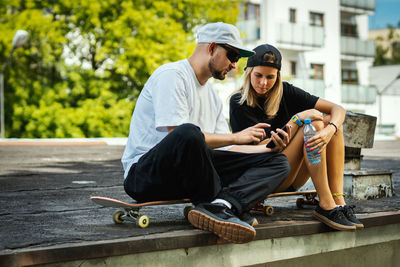 Couple sitting at skateboard park