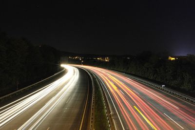 High angle view of light trails on road at night