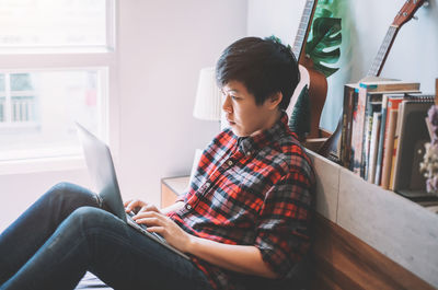 Man using mobile phone at home