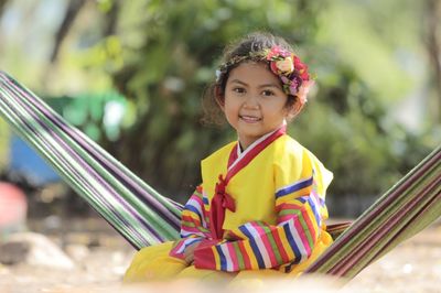 Portrait of cute girl smiling while sitting on hammock