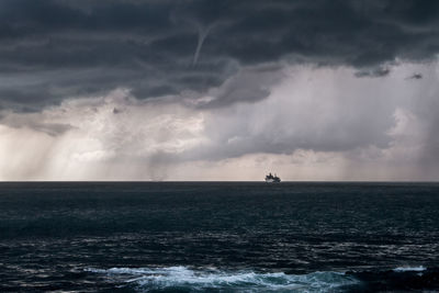 Scenic view of sea against cloudy sky