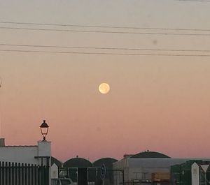 Low angle view of moon against sky during sunset