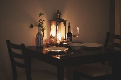 Illuminated lamp on table at home