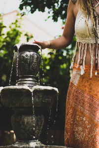 Rear view of woman with statue against blurred background