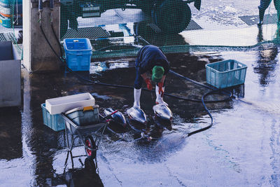 High angle view of men fishing in snow