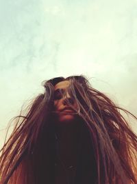Portrait of woman against sky