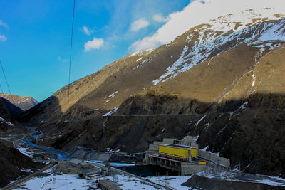 Ski lift over mountains against sky