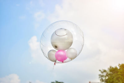 Low angle view of balloons against sky