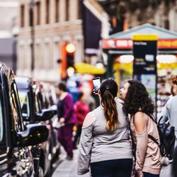 Rear view of people on road in city