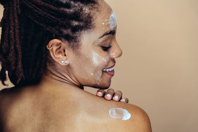 Close-up of young woman against white background