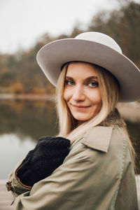 Portrait of smiling young woman in hat