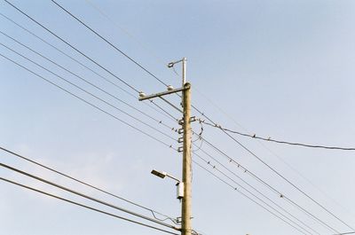 Low angle view of electricity pylon against sky