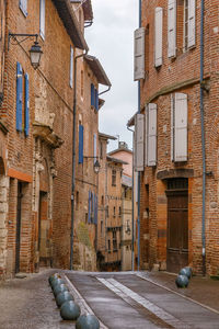 Street amidst buildings in city against sky