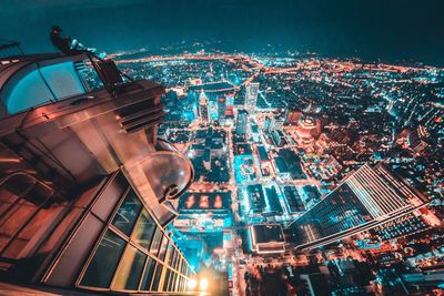 High angle view of city lit up at night