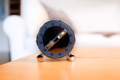 Close-up of clock on table