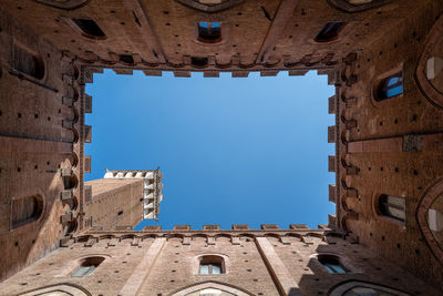 Low angle view of historical building against blue sky