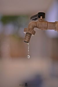 Close-up of metallic faucet outdoors