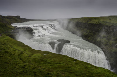 Scenic view of waterfall against clear sky