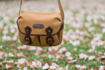 Close-up of bag hanging over field