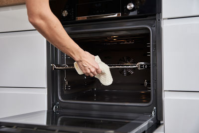 Woman open electric oven door