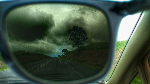 Close-up of side-view mirror of car