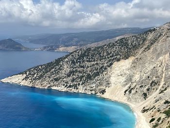 Aerial view of sea and mountains against sky