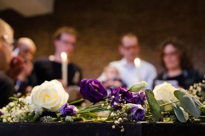 People with lit candles in church