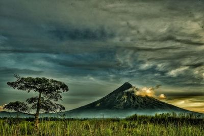 Scenic view of landscape against cloudy sky