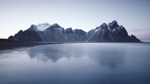 Scenic view of snowcapped mountains against clear sky