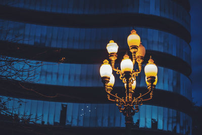 Low angle view of illuminated lamp hanging on ceiling