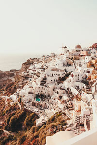 High angle view of townscape by sea against clear sky