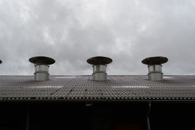 Low angle view of smoke stack against sky