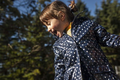 Cheerful girl playing at park