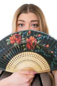 Close-up portrait of woman with hand fan